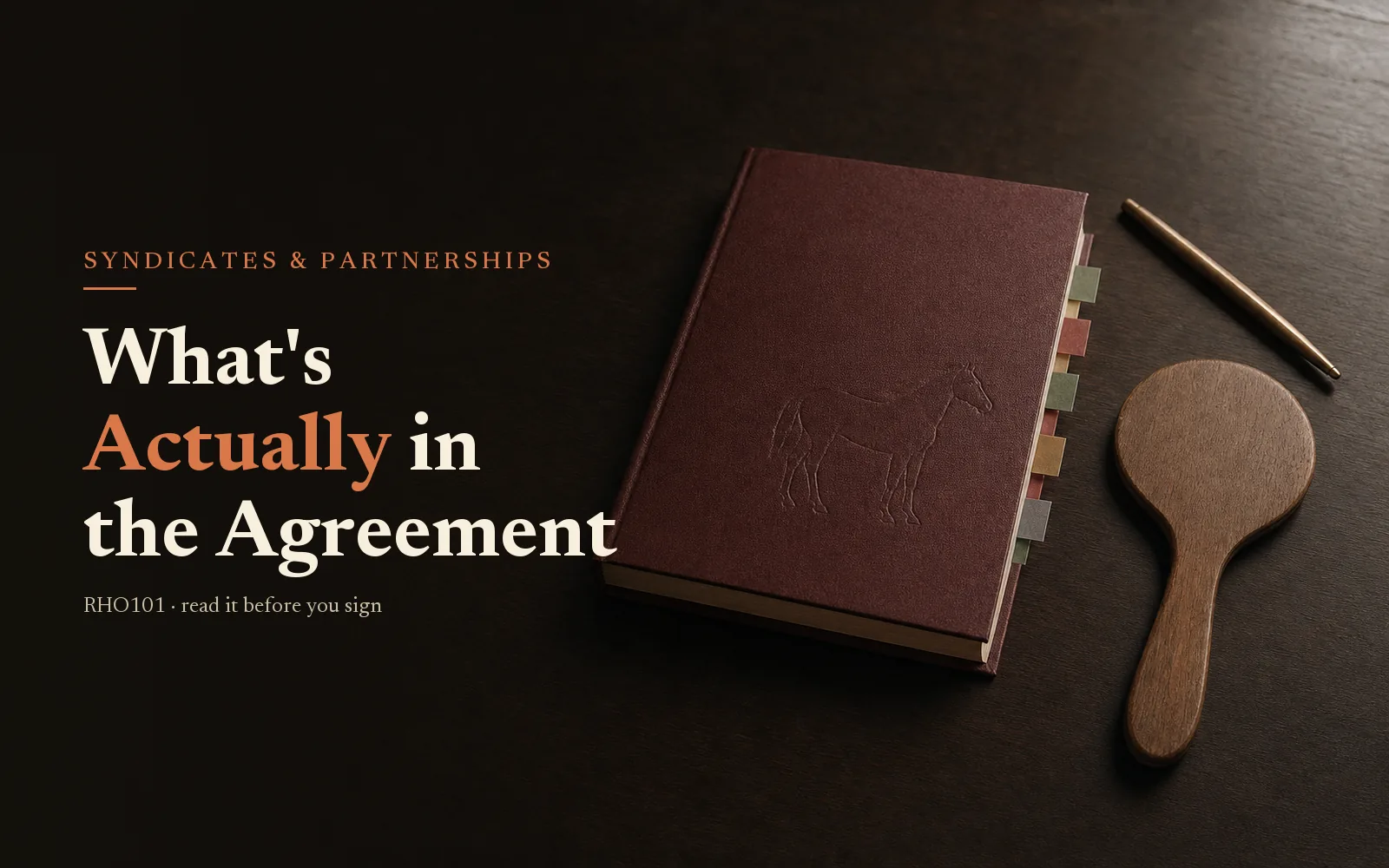 Oxblood sale catalogue and bidder's paddle on dark oak; headline What's Actually in the Agreement