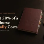 Oxblood thoroughbred sale catalogue and bidder's paddle on dark oak, headed What 50% of a Racehorse Actually Costs