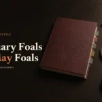 Oxblood thoroughbred sale catalogue and bidder's paddle on dark oak, headline January Foals vs May Foals